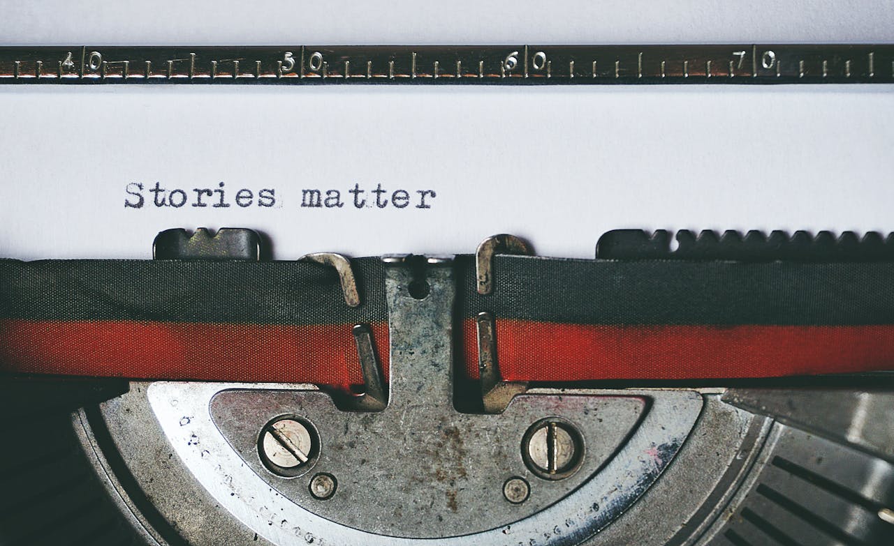 Close-up of a vintage typewriter with the text Stories matter typed on paper, evoking nostalgia.